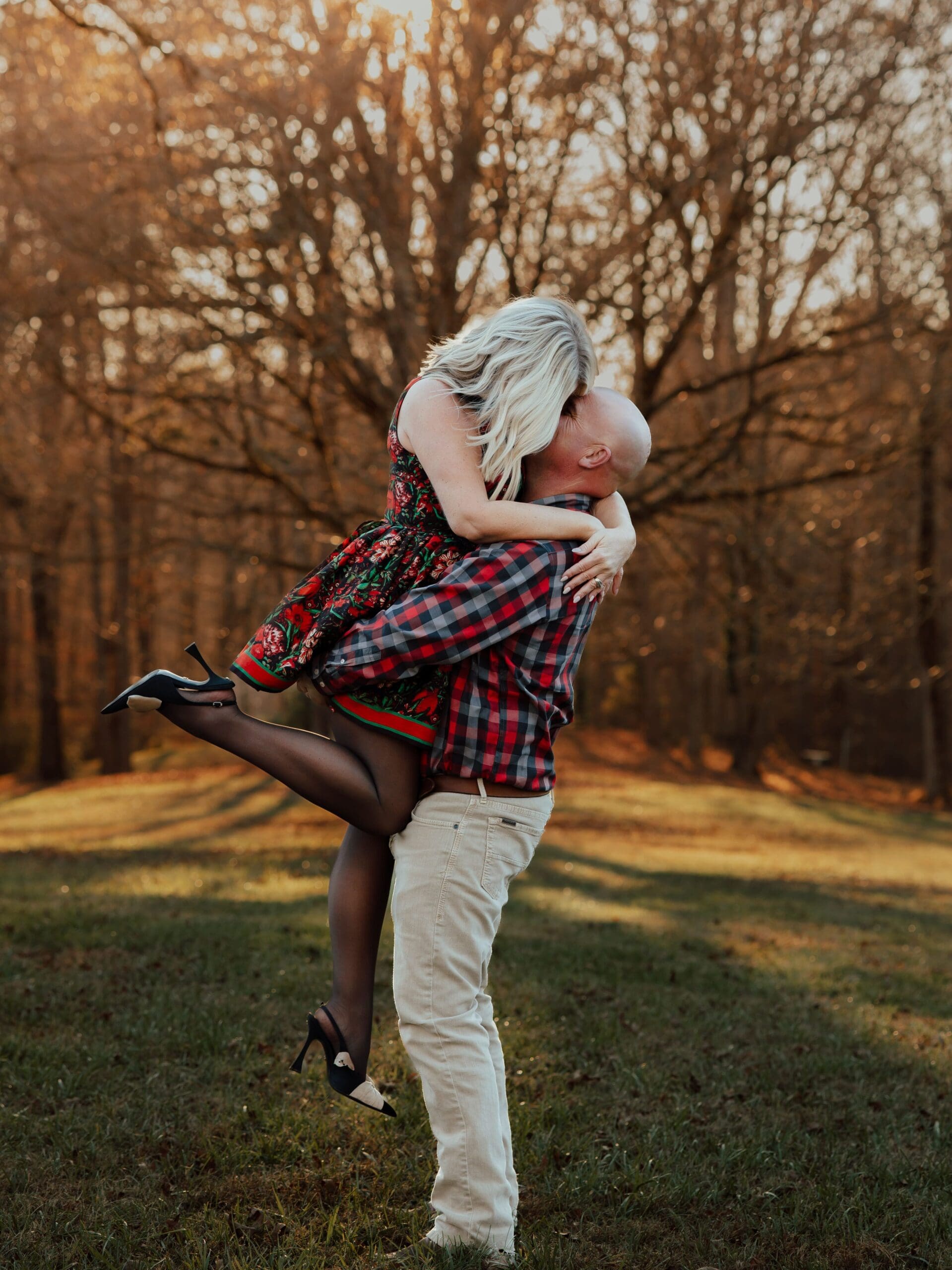 Romantic fall couple portrait of parents embracing and sharing a quiet moment outdoors.
