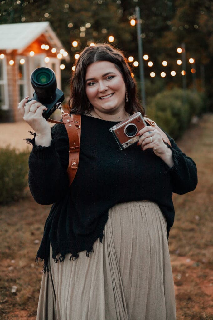 Georgia family photographer poses with both of her cameras for a photo session.