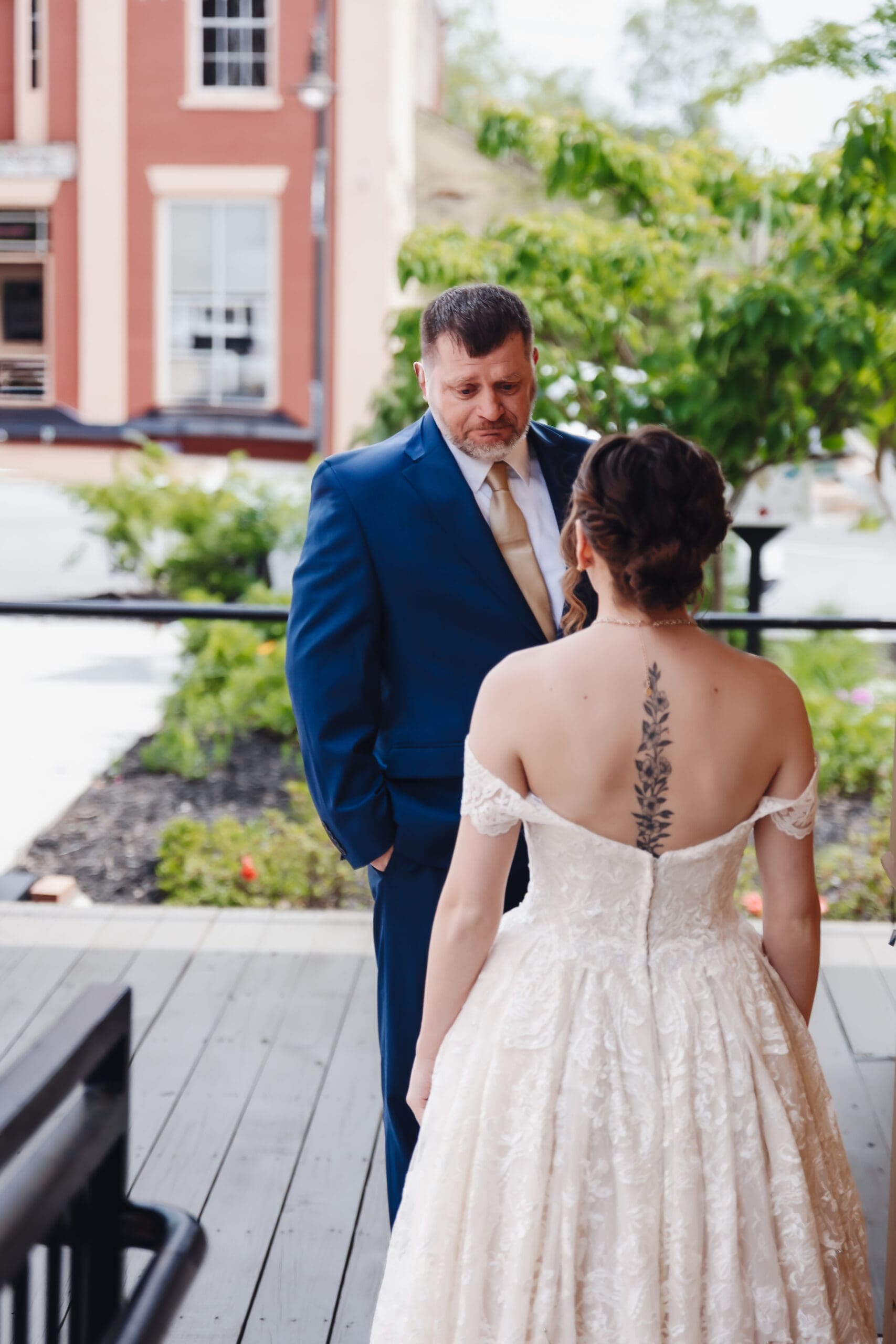 Emotional first look between bride and father during an intimate Georgia wedding, captured on a quiet outdoor balcony