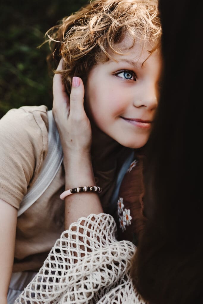 Young boy smiling at his mom during a motherhood session at Powell Barn.