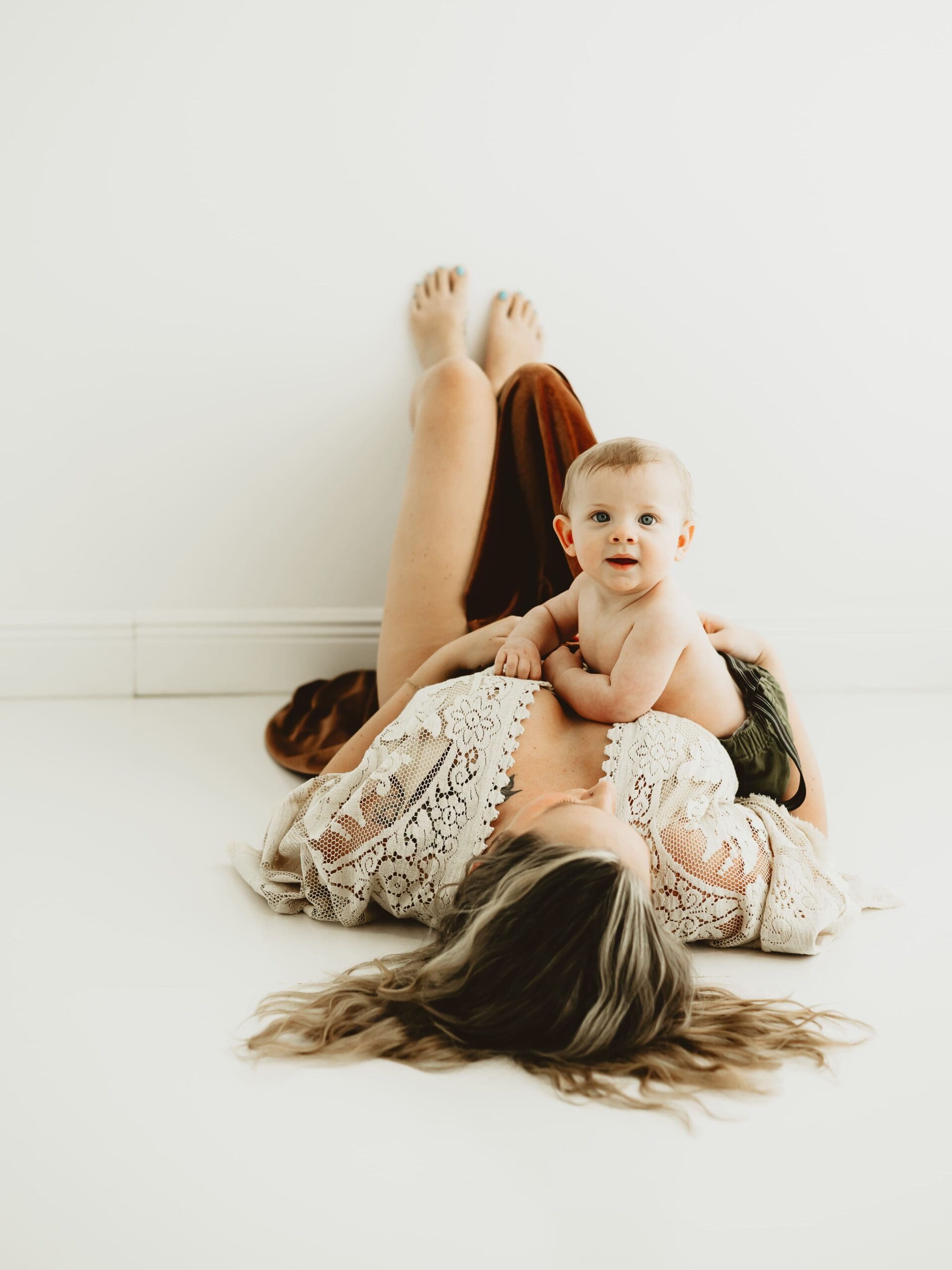 Baby laying on mother during a Georgia newborn photography motherhood session.